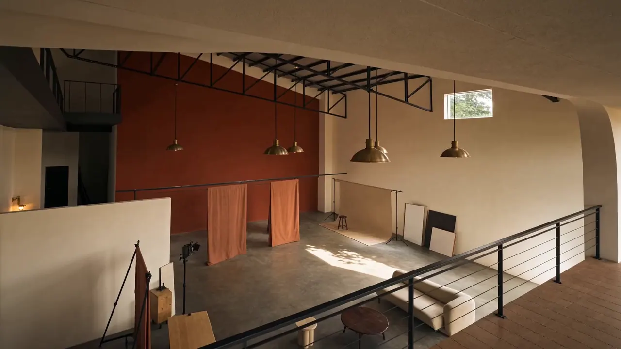 Slow camera push through the studio house: hero space, mezzanine self-shoot booth, and coffee bar.